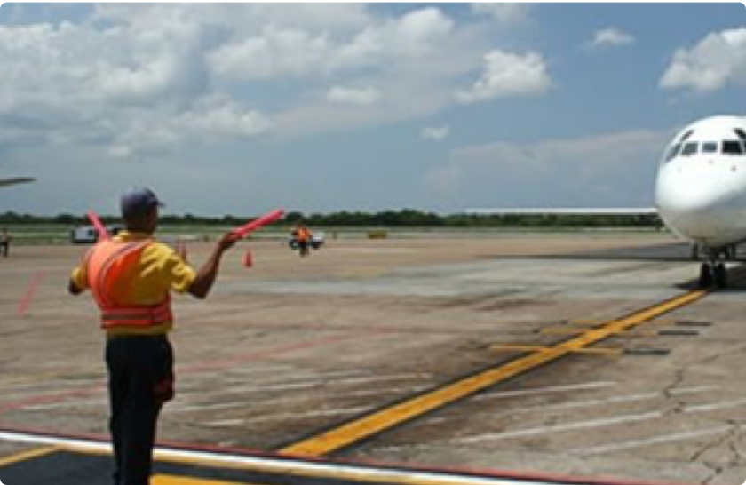 Ramp agent marshalling an aircraft on the apron at Trabzon Airport